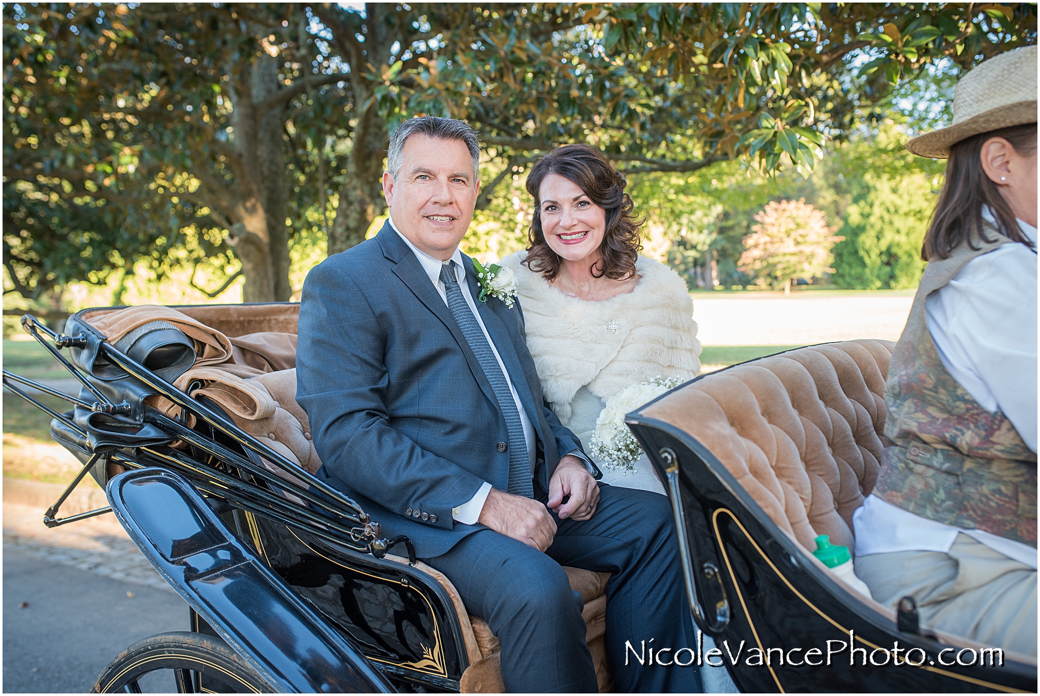The newlyweds enjoy a carriage ride around the park together directly after their wedding at Maymont Park.