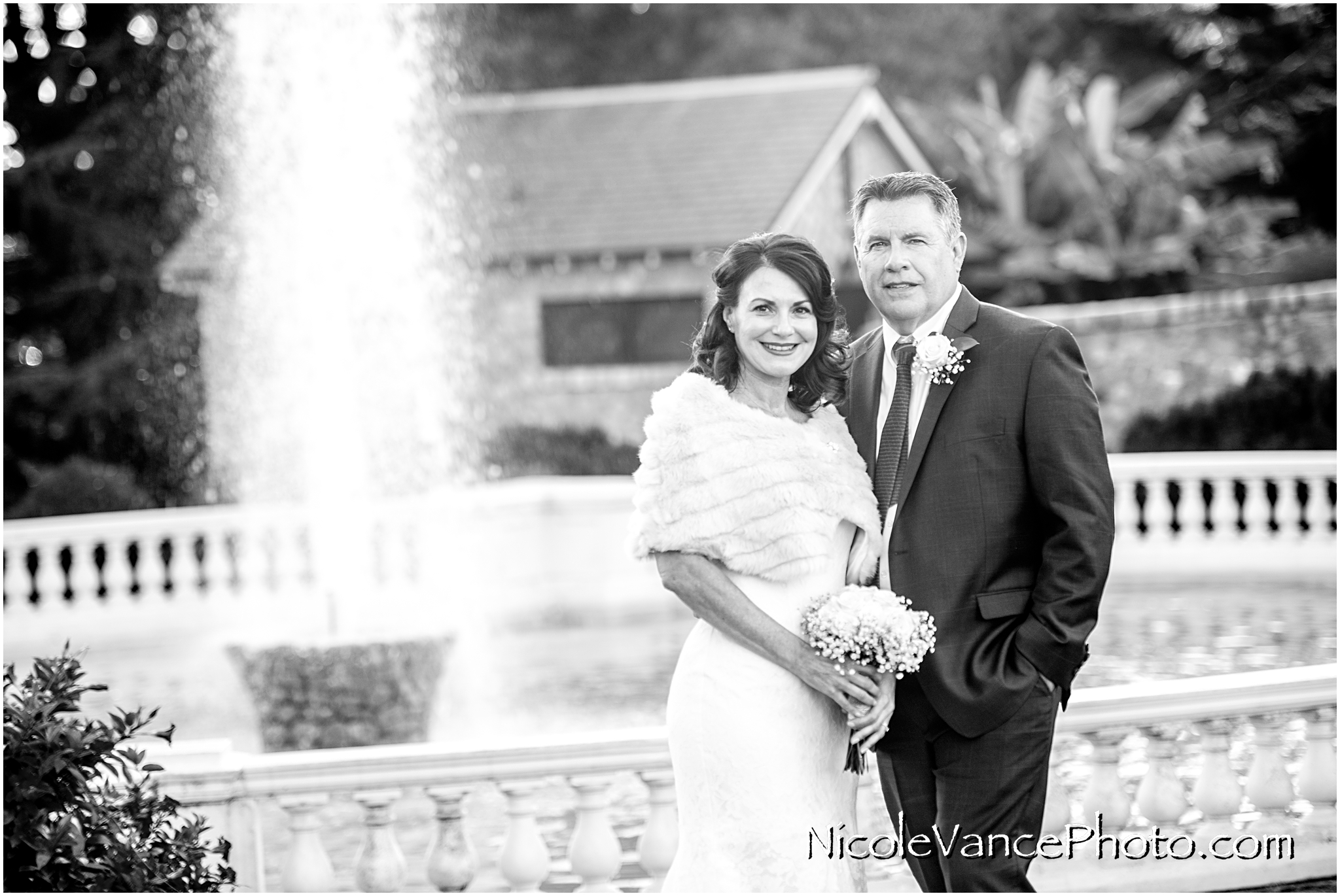 The bride and groom pose by the fountain at Maymont Park in Richmond, VA.