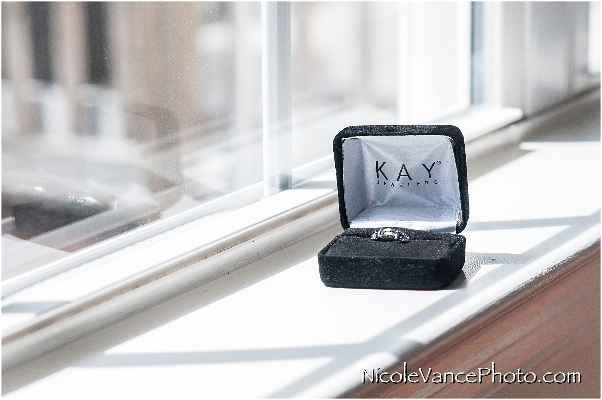 The bride's ring sit in the window, waiting for their wedding ceremony in just a few hours.