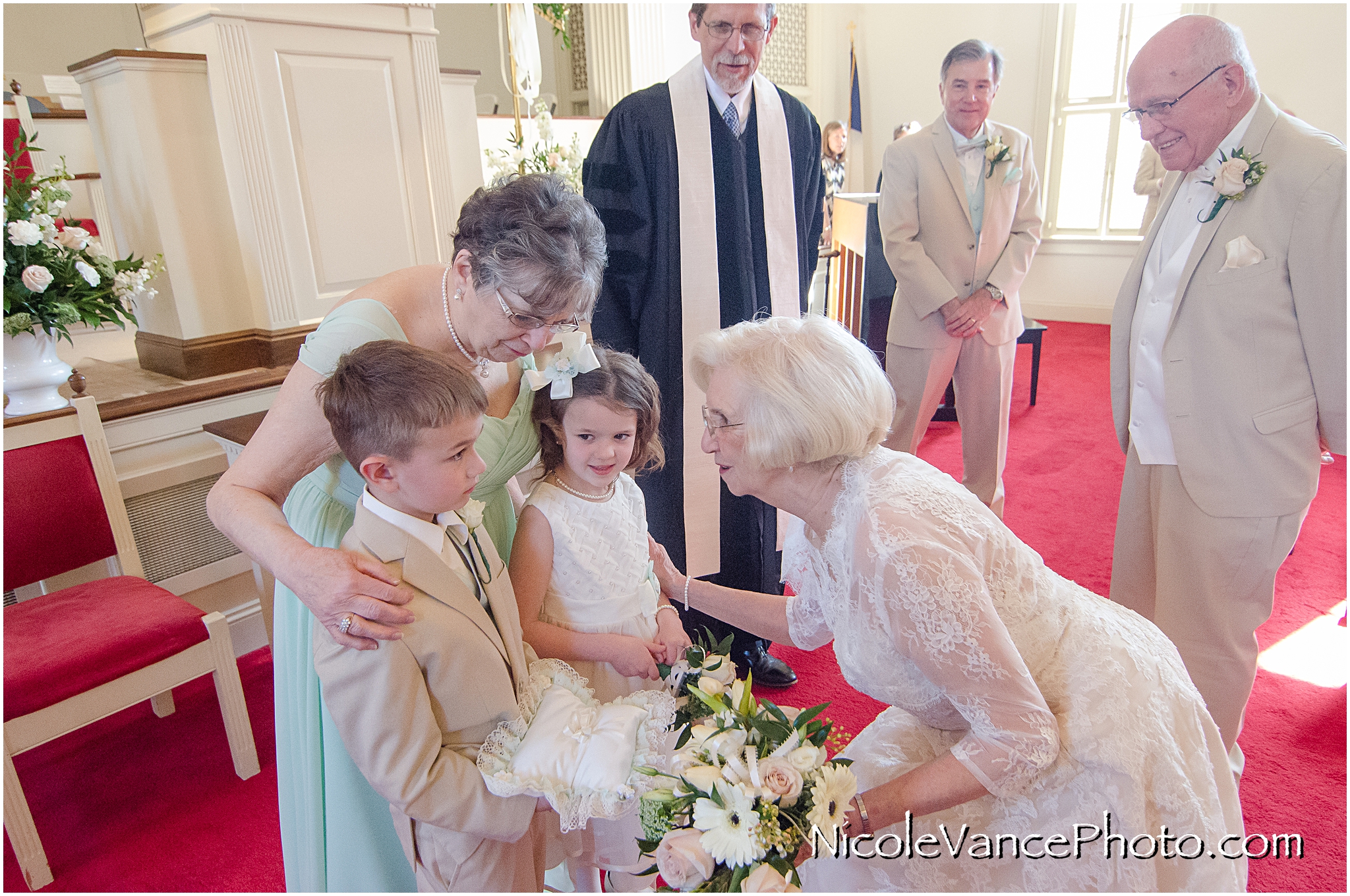A tender moment between the bride and her child attendants