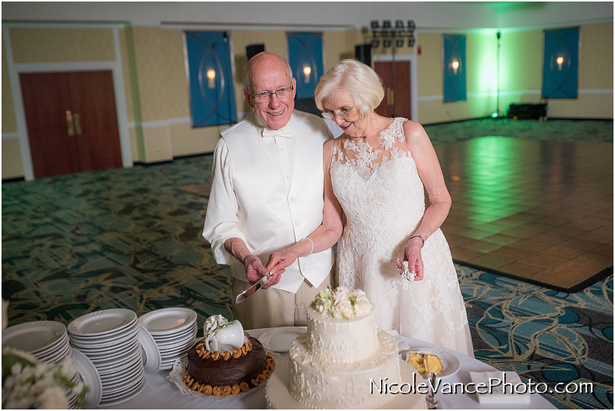 The bride and groom cut the cake in the ballroom at the Doubletree by Hilton Richmond-Midlothian.
