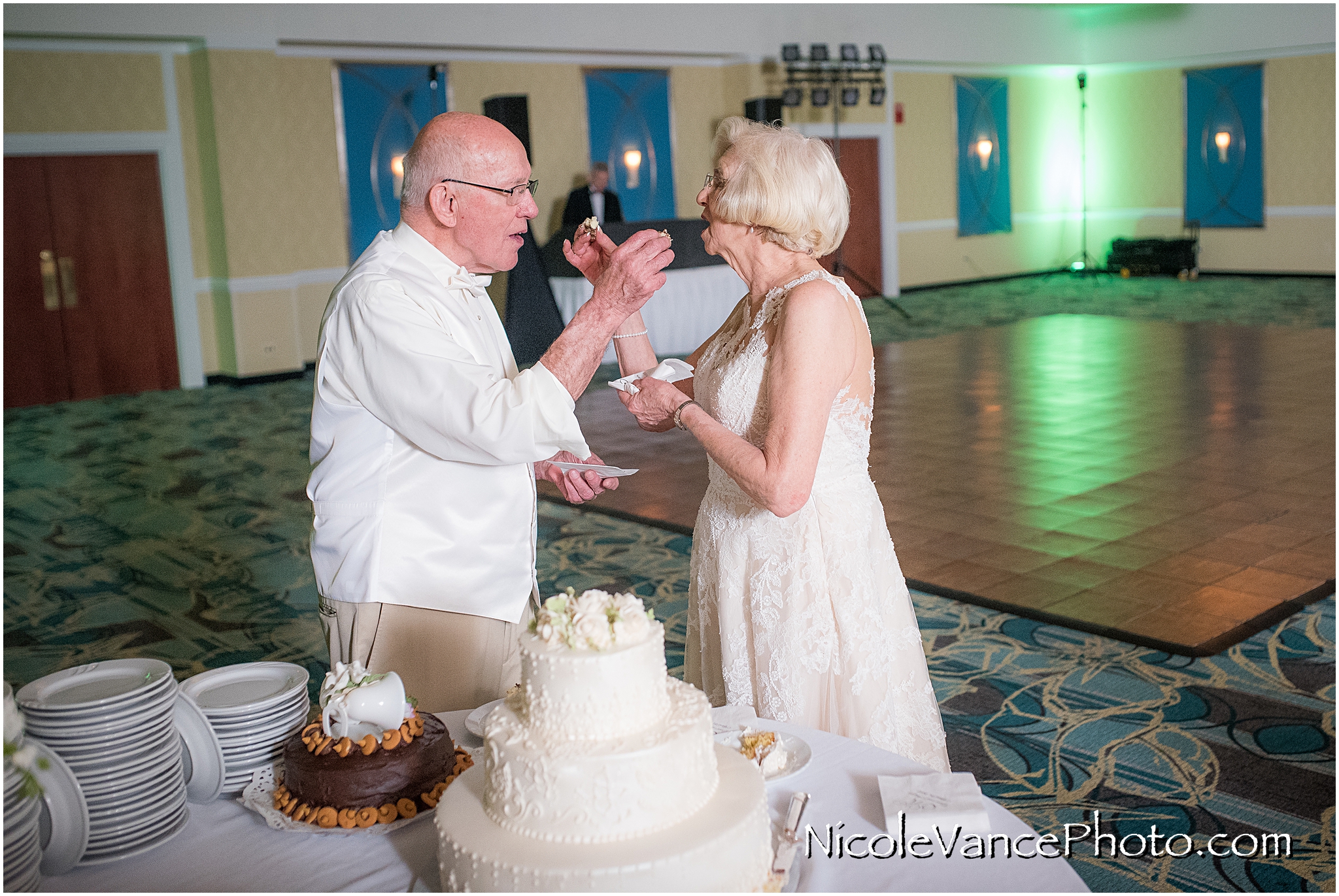 The bride and groom cut the cake in the ballroom at the Doubletree by Hilton Richmond-Midlothian.